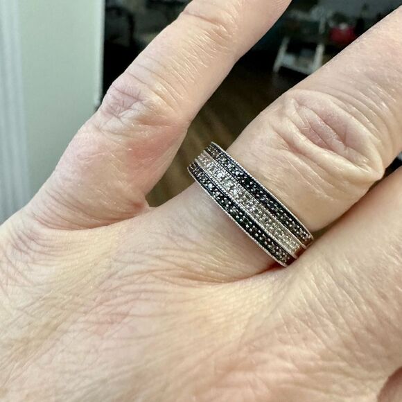 Sterling silver band with small diamond chips.